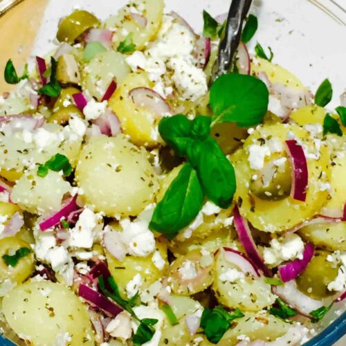 A bowl full of delicious potato, olives and feta cheese salad.