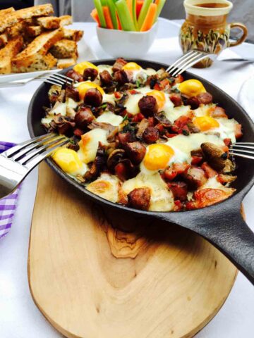 Breakfast: a skillet filled with quail eggs, mushrooms and bacon.