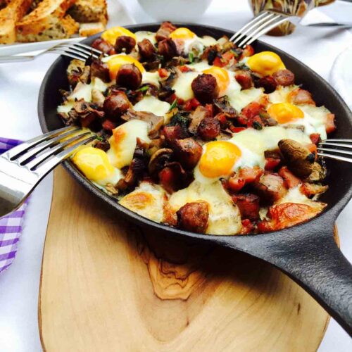 Breakfast: a skillet filled with quail eggs, mushrooms and bacon.