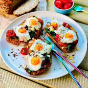 Quail eggs with salmon, spinach and cherry tomatoes breakfast.