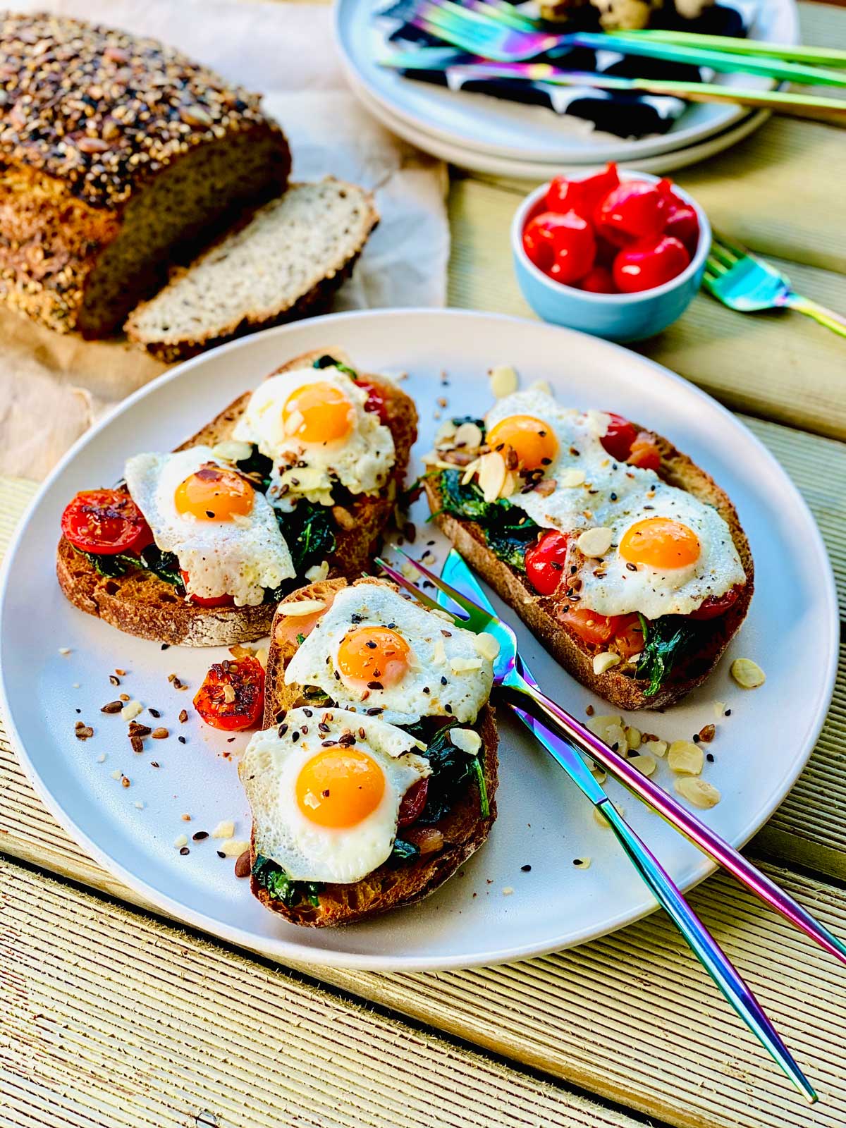 Quail eggs with salmon, spinach and cherry tomatoes.