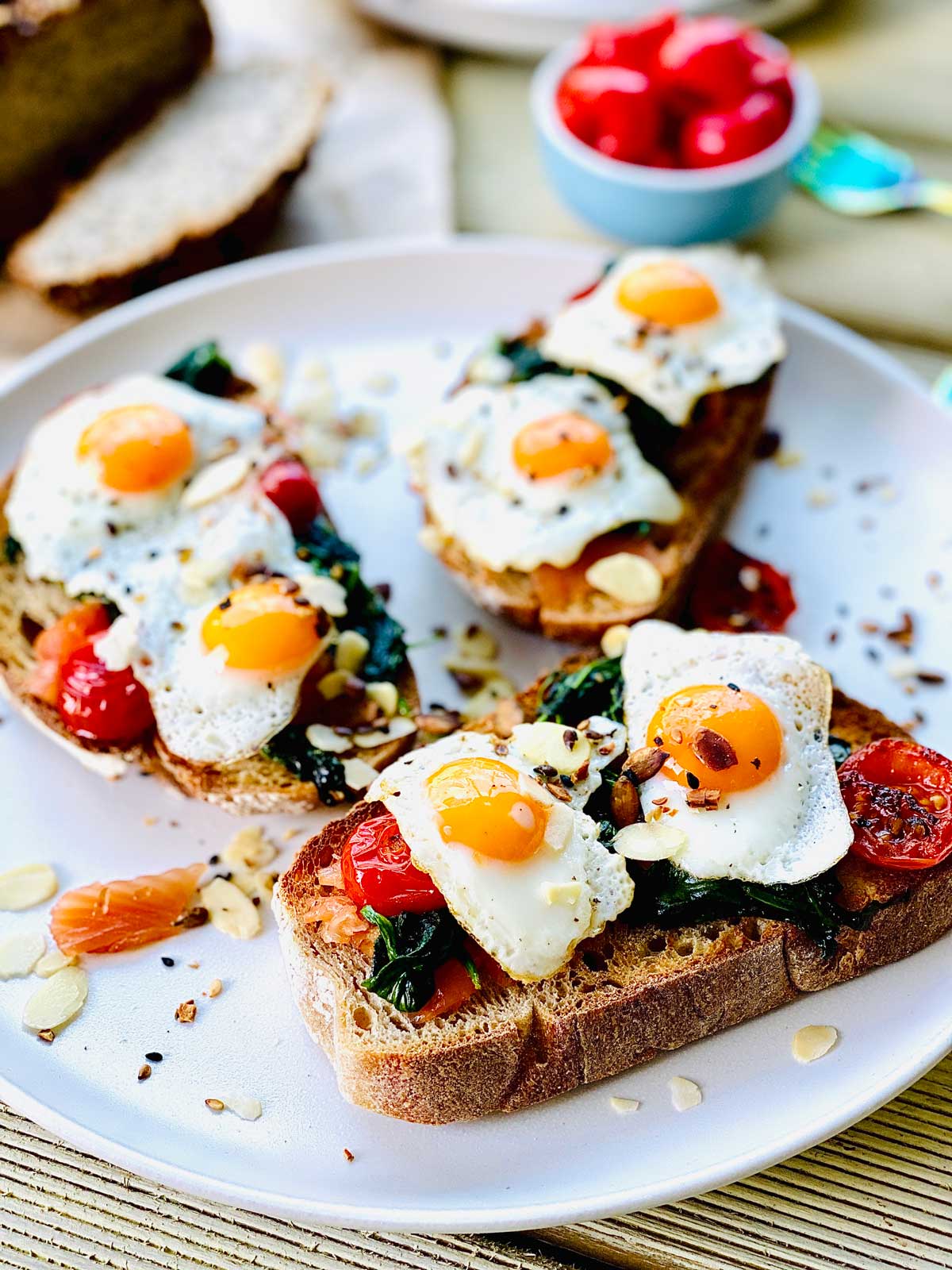 Open sandwich with quail eggs, salmon and spinach.