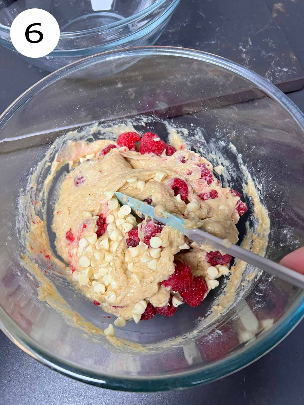 Raspberry chocolate muffin batter mix with white chocolate chips and fresh raspberries mixed in.