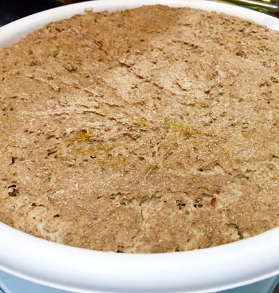 Rye sourbread dough in a white bowl