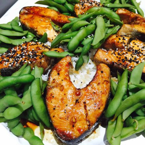 Salmon teriyaki with edamame and rice, on a white plate