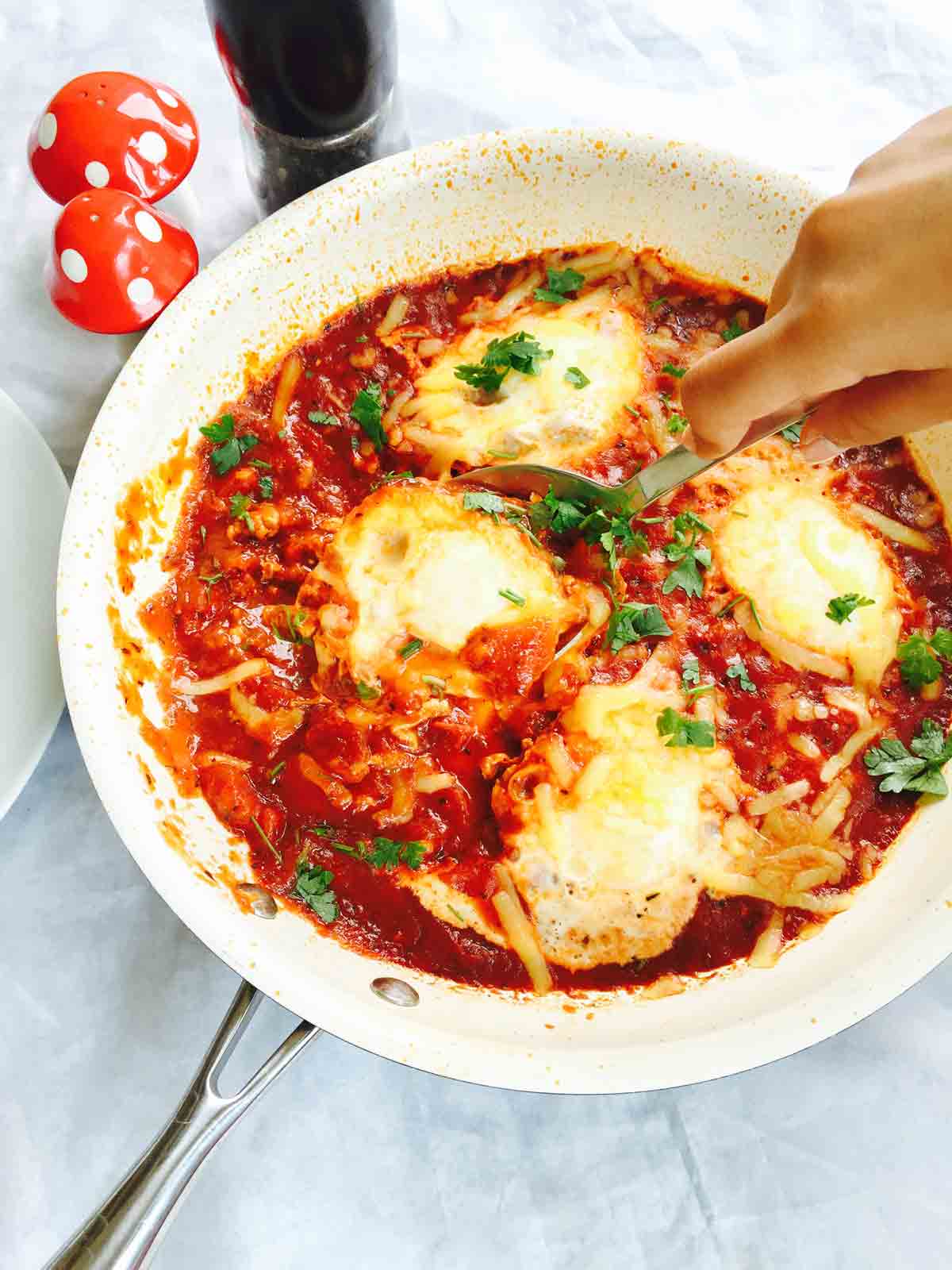 Grabbing a chunk of shakshuka, all prepared for an awesome egg brunch.