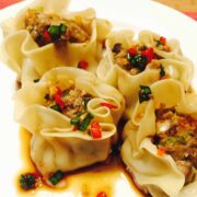 Veal steamed dumplings or dim sum on a white plate