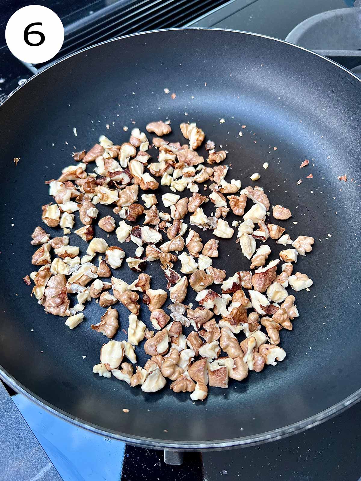 Walnut pieces in a frying pan.