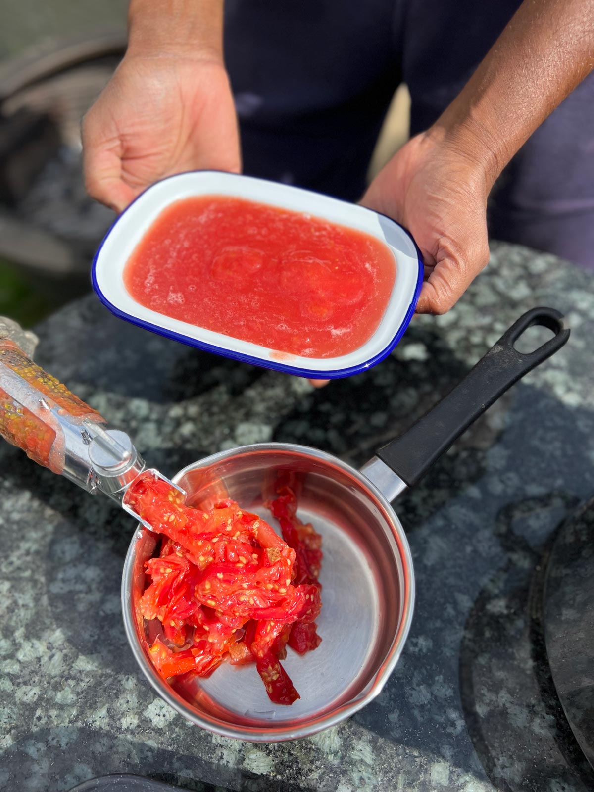 Passata on the making, a white metallic dish with tomato juice.